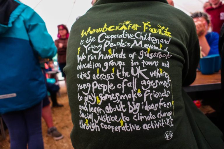 the back of someone wearing a hoody with iwoodcraft folk written on it