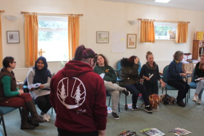 Adult volunteers n a circle in discussion