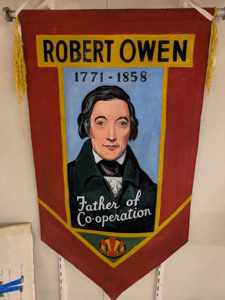 Robert Owen painted onto banners from Birmingham Woodcraft Folk in the 1950s, loaned to the exhibition by John Boyle for Rochdale Exhibition.