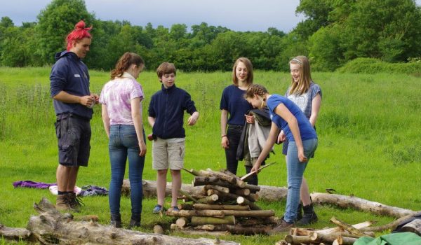 A group of Venturers building a campfire