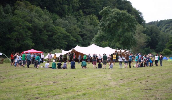 large circle of people at a woodcraft folk AGM in a field
